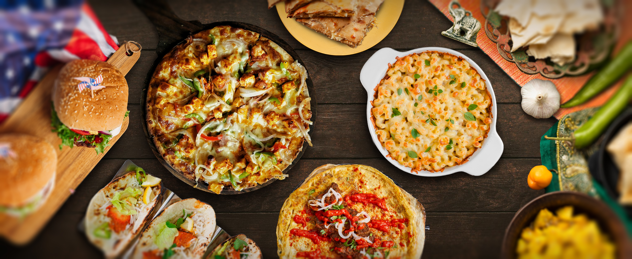 Indian American foods. Fusion cuisines. Fusion foods. Butter Chicken Mac and Cheese. Breakfast Burrito with Paratha. Tandoori Chicken Tacos. Paneer Tikka Pizza.